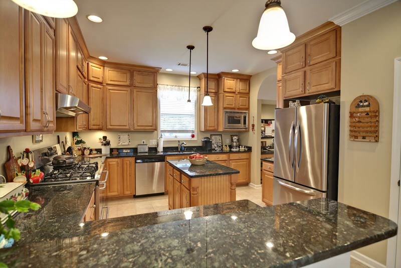 Granite Countertops green maple cabinets Bloomington Indiana Surfaces